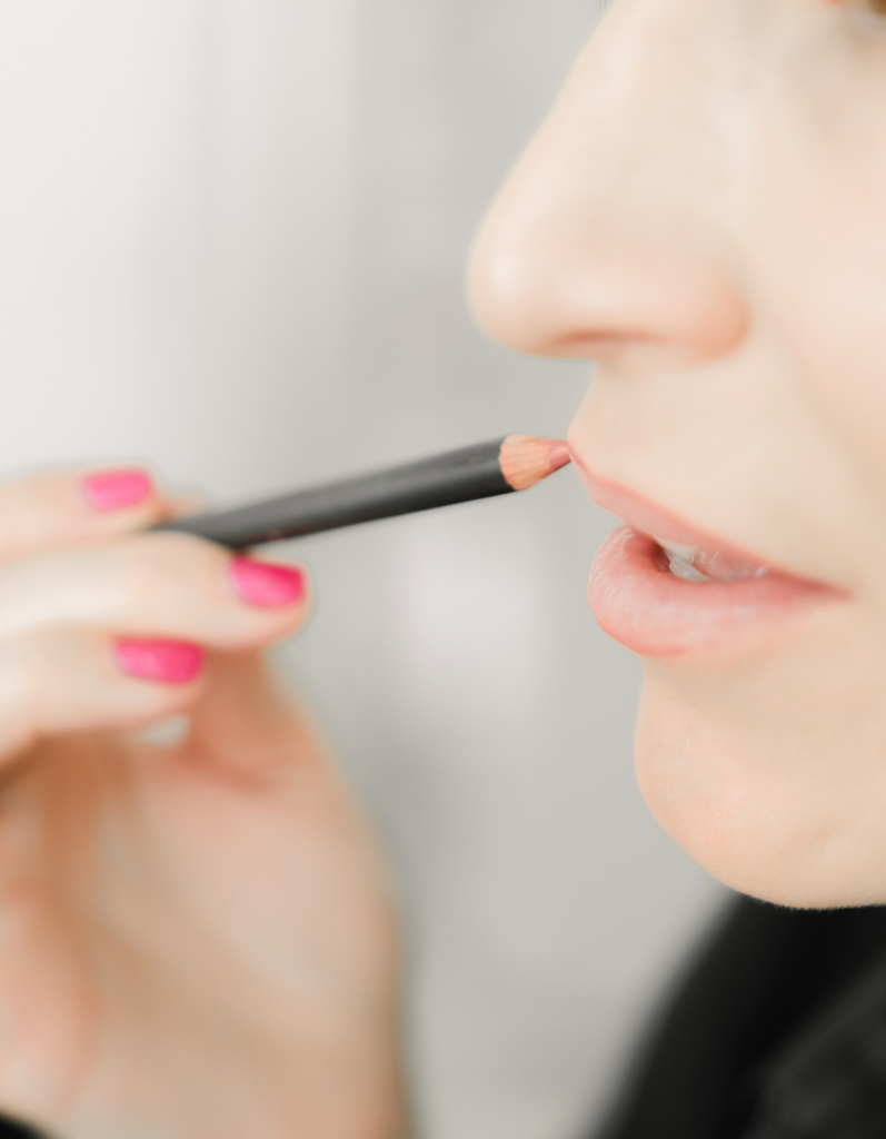 a woman doing permanent lip makeup